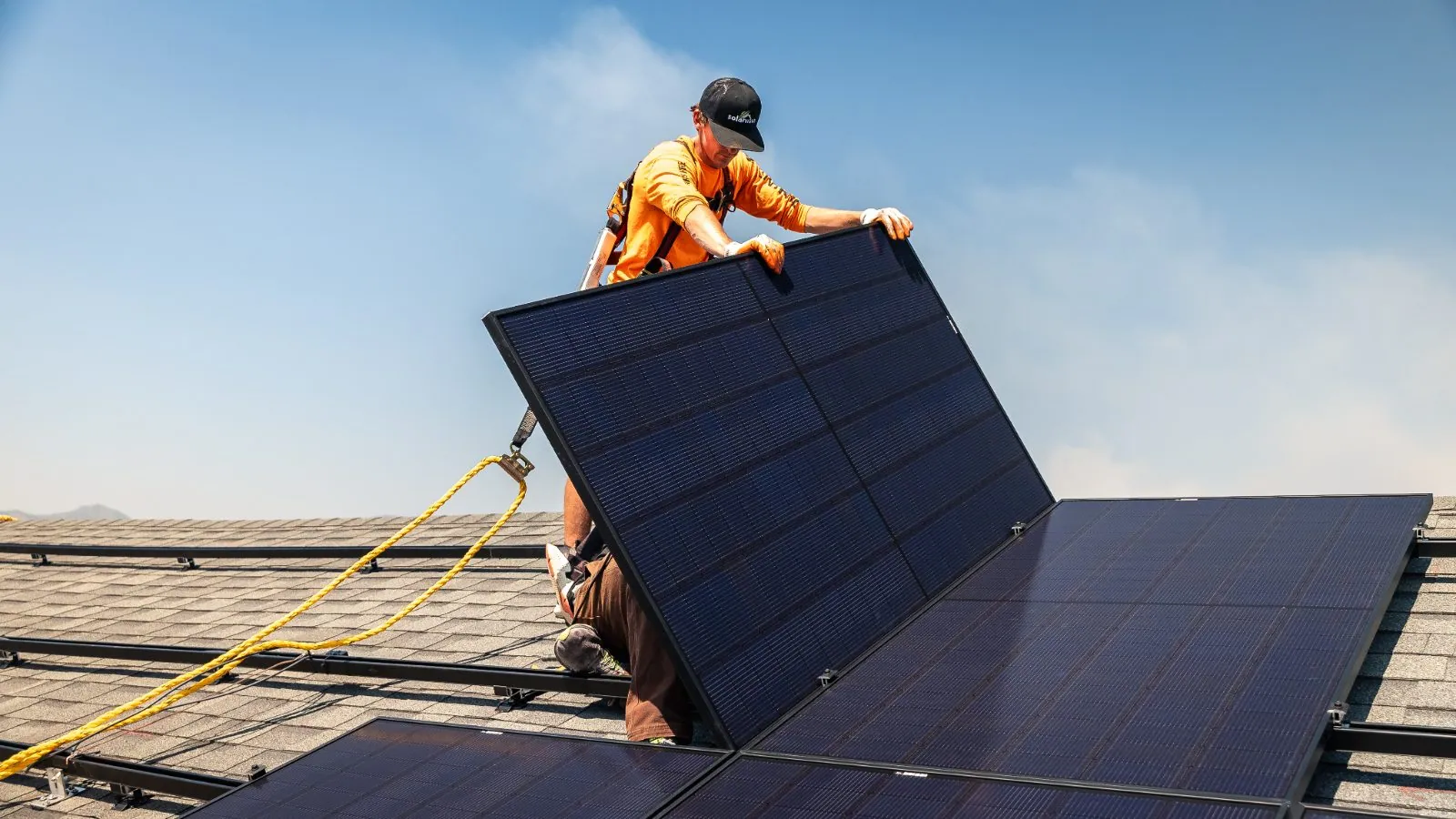 Solar Wave installer mounting a panel on a Colorado rooftop