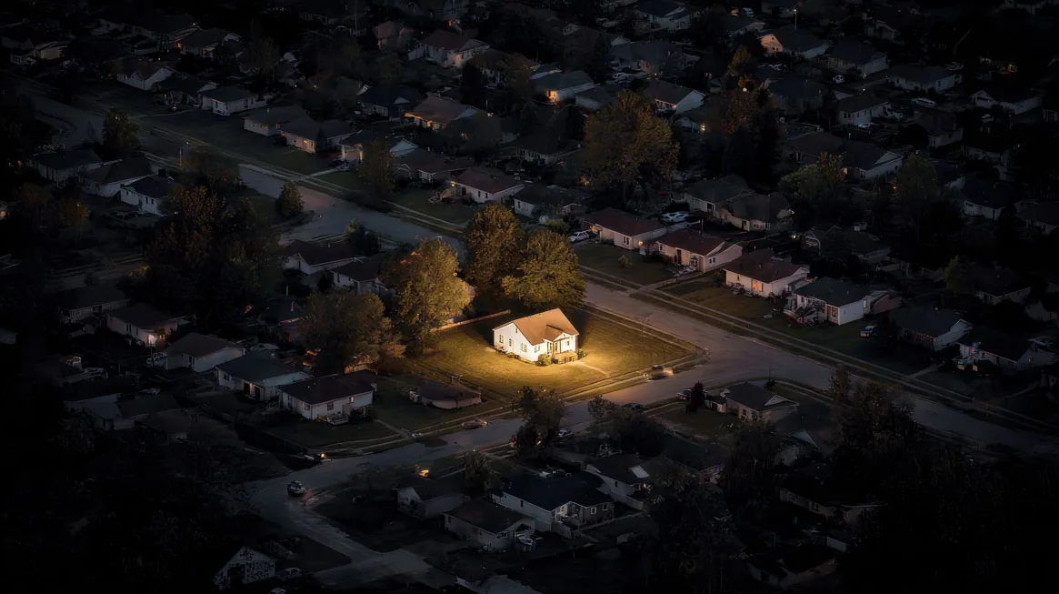 A single Colorado home with its lights on during a neighborhood power outage